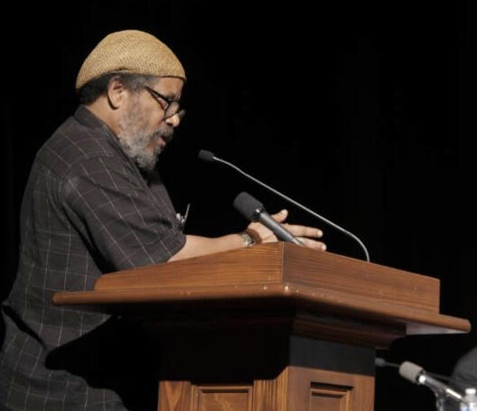 Michael at podium Michael Simmons speaking at a podium